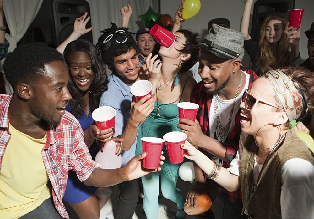 College guys group having fun and drinking at a RUSH Week party.