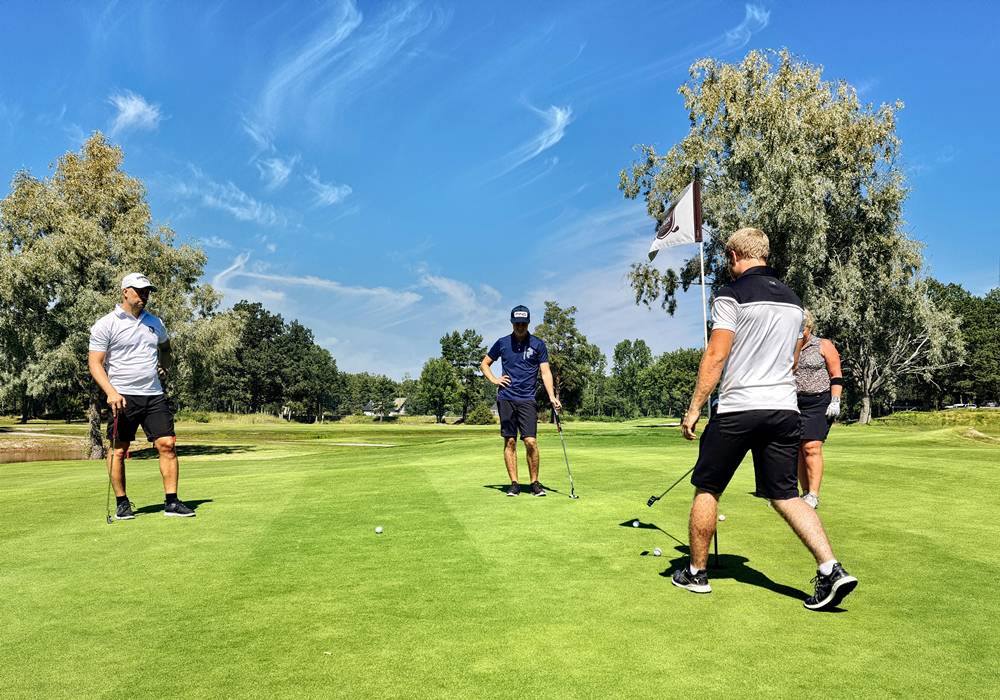 Golf group on the green.