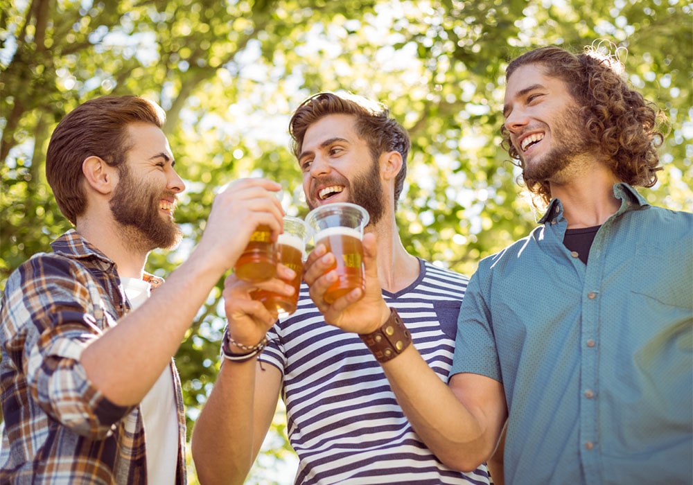 Three men toasting with beer.