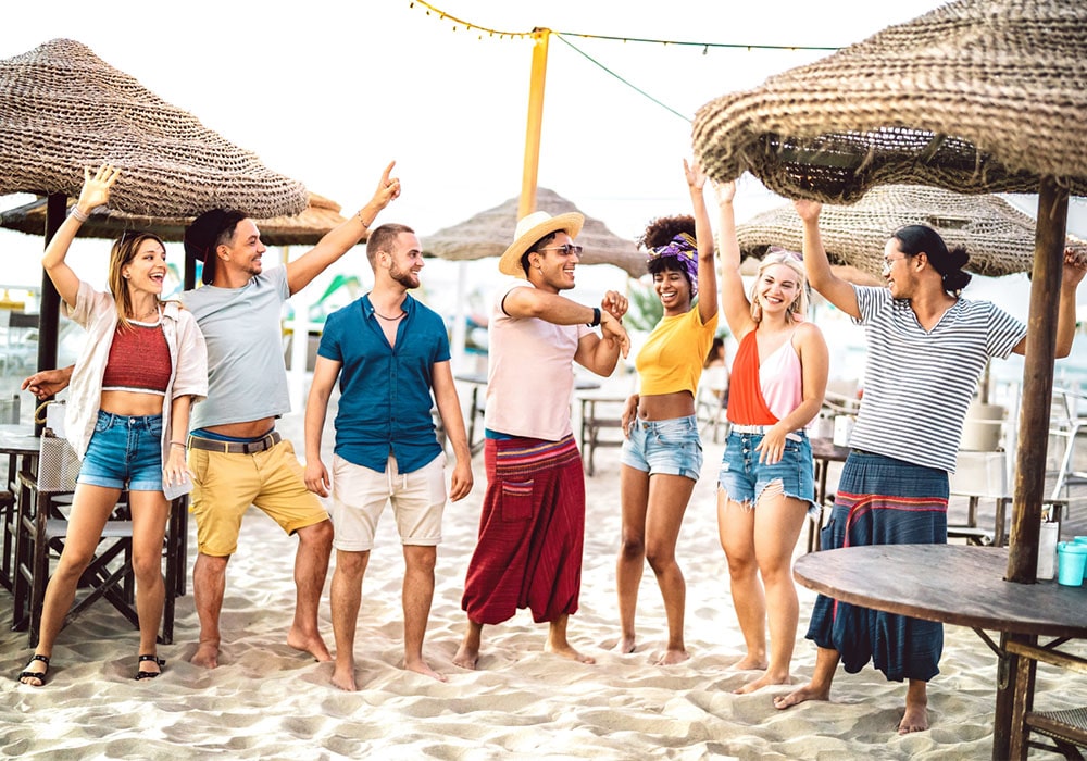 Group of young adults at a tiki themed beach party.