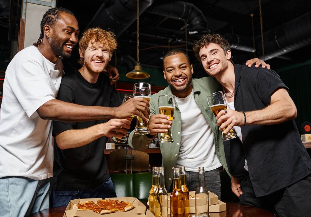 Party group enjoying pizza and beer at a vacation rental in Scottsdale.